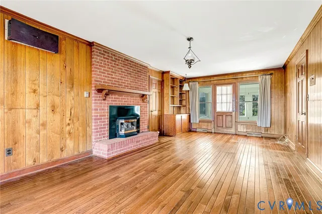 a view of a livingroom with wooden floor and fireplace