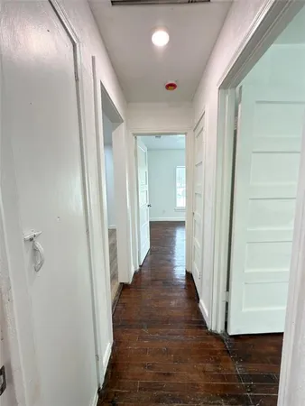 a view of a hallway with wooden floor