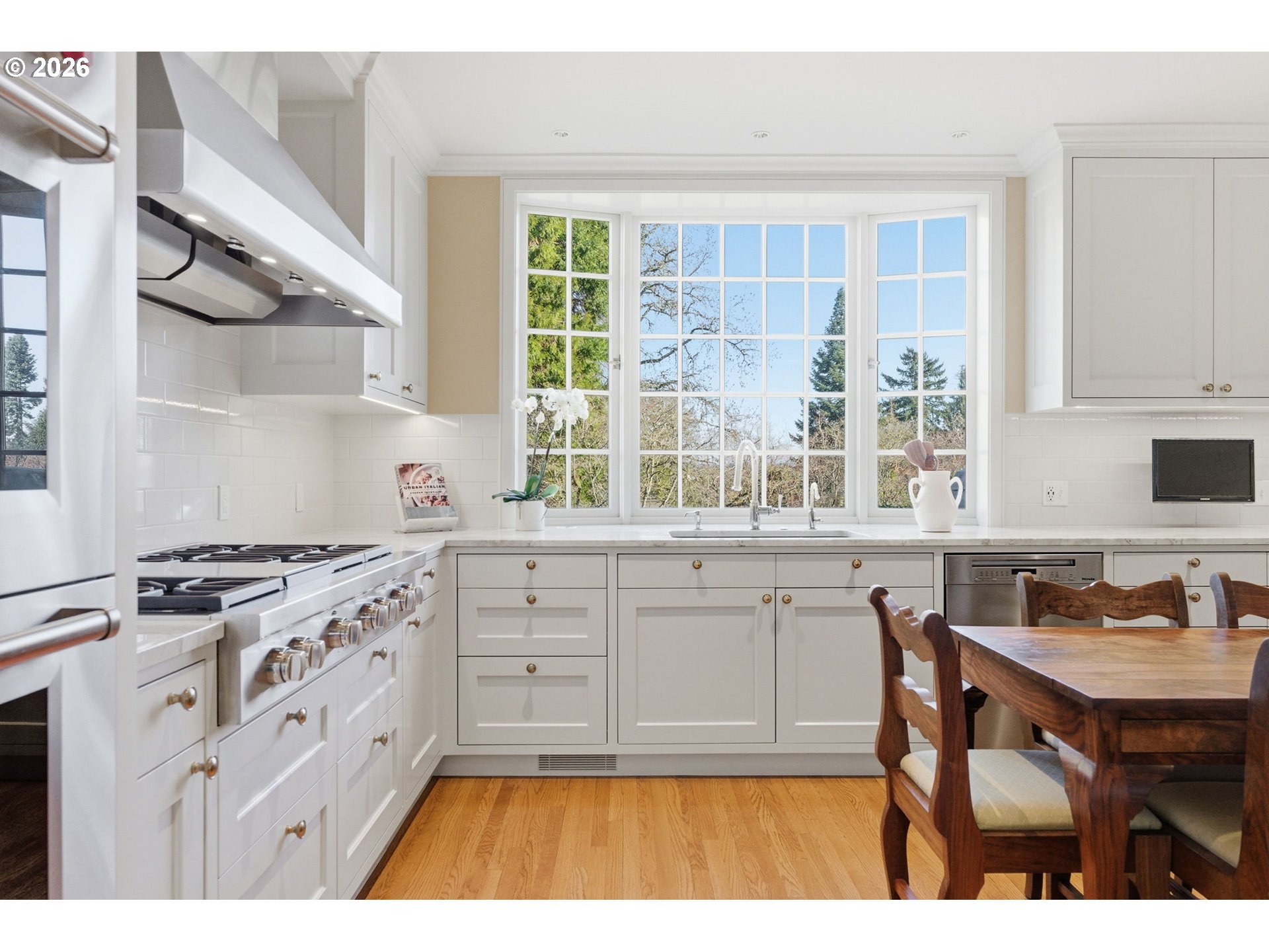 2393 South Military Road Portland, OR 97219 - Photo 16 of 48 a kitchen with stainless steel appliances granite countertop a stove a sink and a microwave