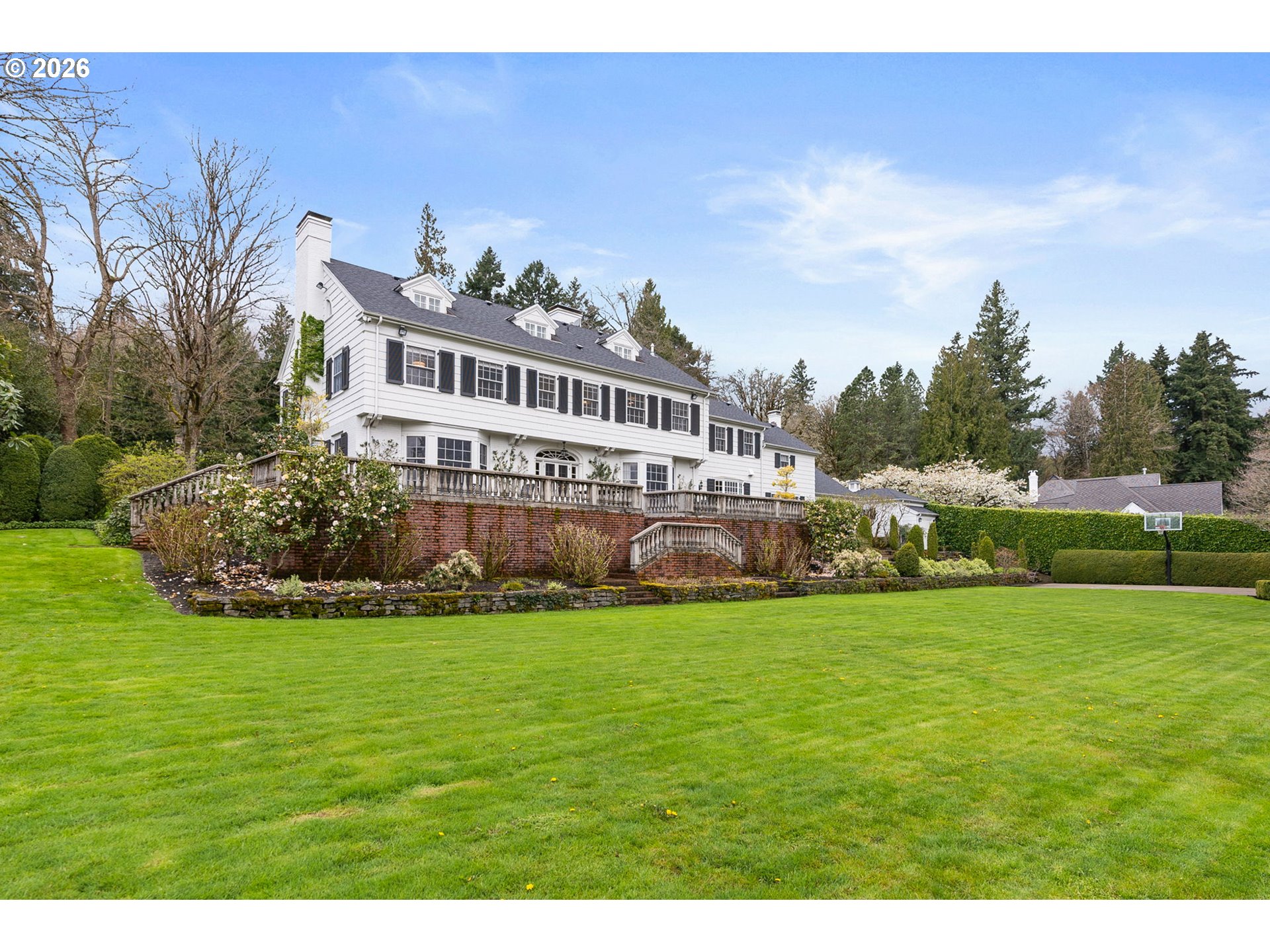 2393 South Military Road Portland, OR 97219 - Photo 36 of 48 a view of a house with a big yard and large trees