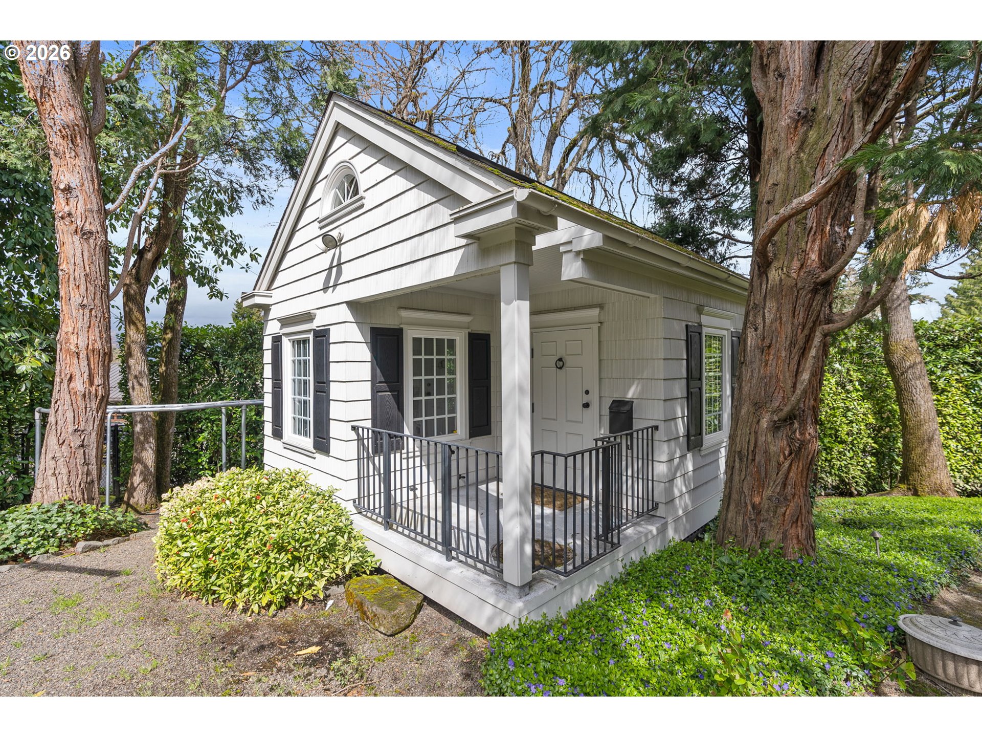 2393 South Military Road Portland, OR 97219 - Photo 41 of 48 a view of a house with a small yard and a large tree