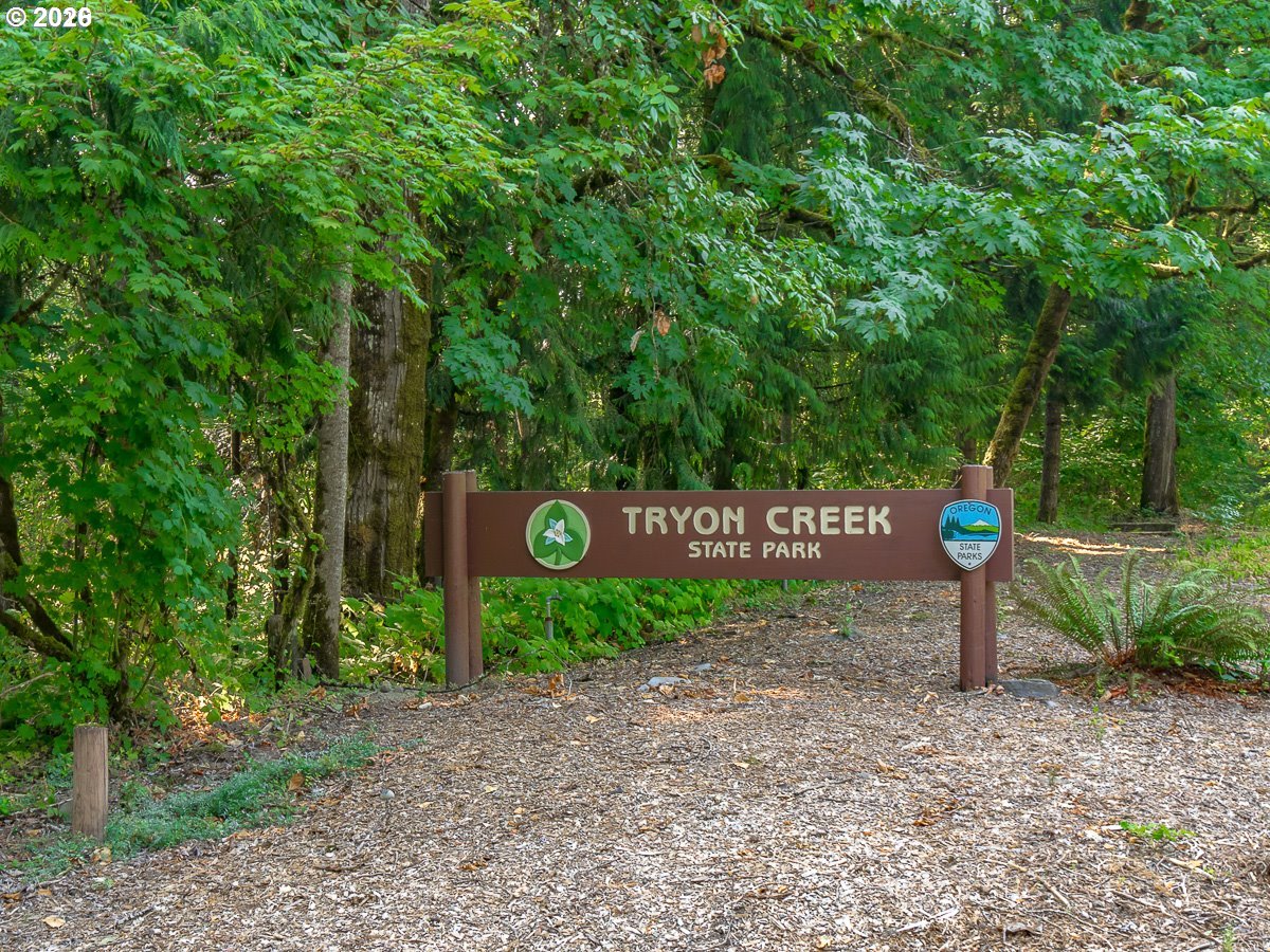 2393 South Military Road Portland, OR 97219 - Photo 47 of 48 a street sign that is next to a road