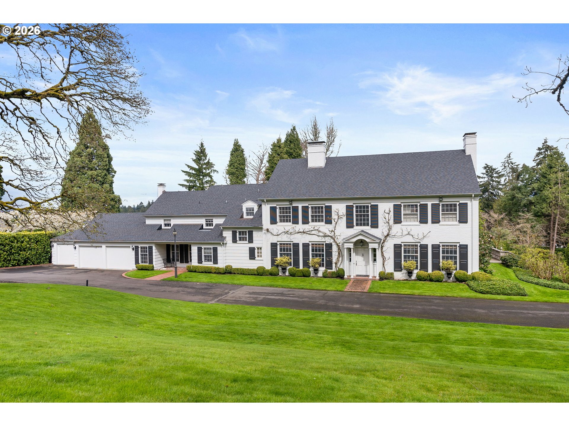 2393 South Military Road Portland, OR 97219 - Photo 6 of 48 a front view of a house with a garden and trees