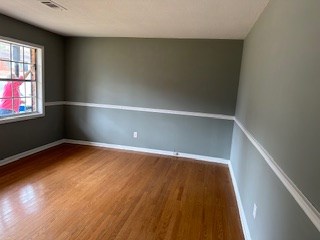 6229 Potomac Circle Columbus, GA 31909 - Photo 4 of 14 an empty room with wooden floor and windows
