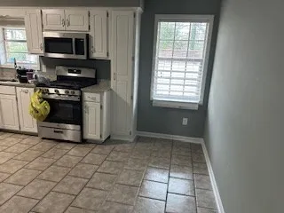 a kitchen with stainless steel appliances a stove a microwave and a sink