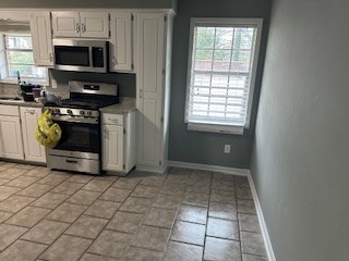 6229 Potomac Circle Columbus, GA 31909 - Photo 6 of 14 a kitchen with stainless steel appliances a stove a microwave and a sink