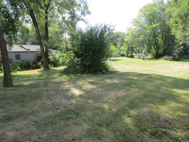 26211 West Rollins Road Ingleside, IL 60041 - Photo 3 of 16 a view of outdoor space with trees all around