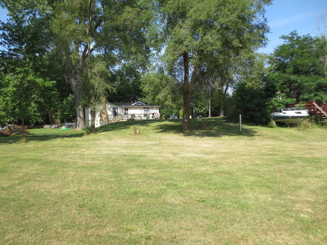 26211 West Rollins Road Ingleside, IL 60041 - Photo 6 of 16 a view of a swimming pool with a big yard and large trees