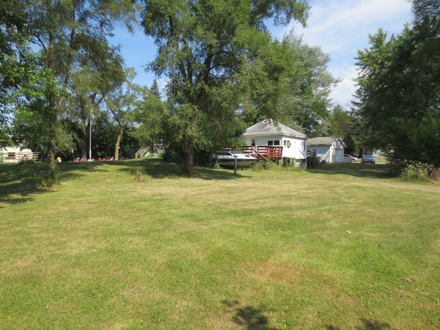 26211 West Rollins Road Ingleside, IL 60041 - Photo 8 of 16 a backyard of a house with swimming pool and green space