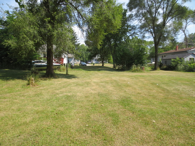 26211 West Rollins Road Ingleside, IL 60041 - Photo 9 of 16 a swimming pool with outdoor seating and yard