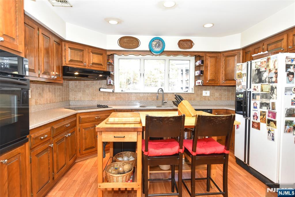 951 Berdan Avenue Wayne, NJ 07470 - Photo 12 of 39 a kitchen with stainless steel appliances a stove a sink and a microwave