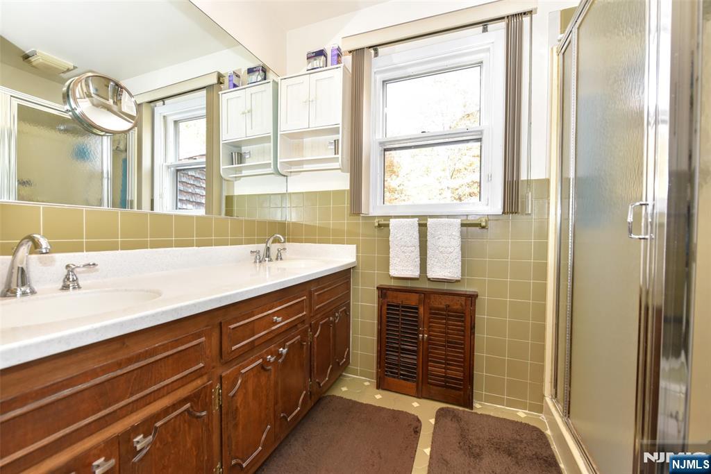 951 Berdan Avenue Wayne, NJ 07470 - Photo 16 of 39 a spacious bathroom with a granite countertop sink mirror and a shower