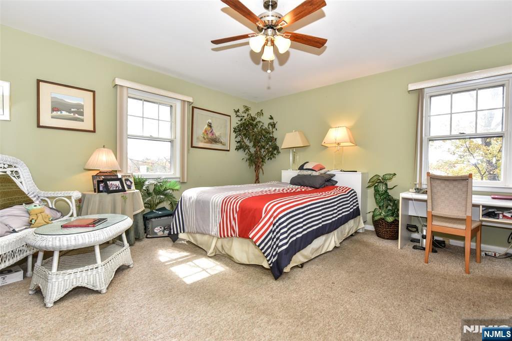 951 Berdan Avenue Wayne, NJ 07470 - Photo 17 of 39 a bedroom with a bed and a chandelier