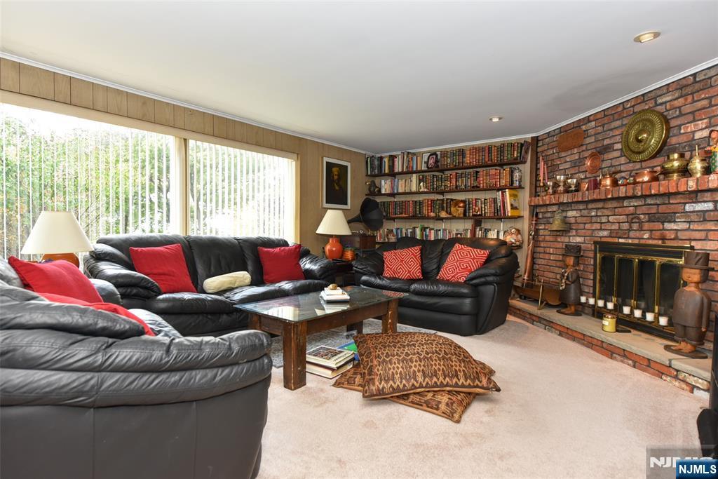 951 Berdan Avenue Wayne, NJ 07470 - Photo 23 of 39 a living room with furniture a rug and a fireplace