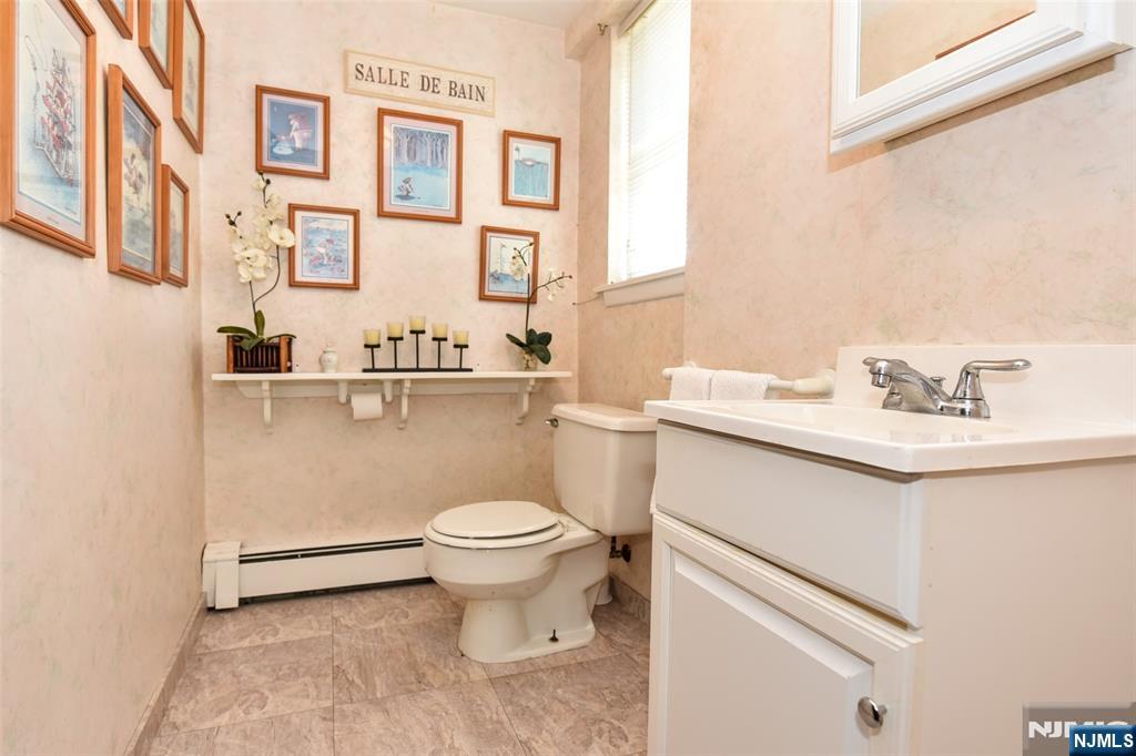 951 Berdan Avenue Wayne, NJ 07470 - Photo 29 of 39 a bathroom with a sink toilet and a mirror