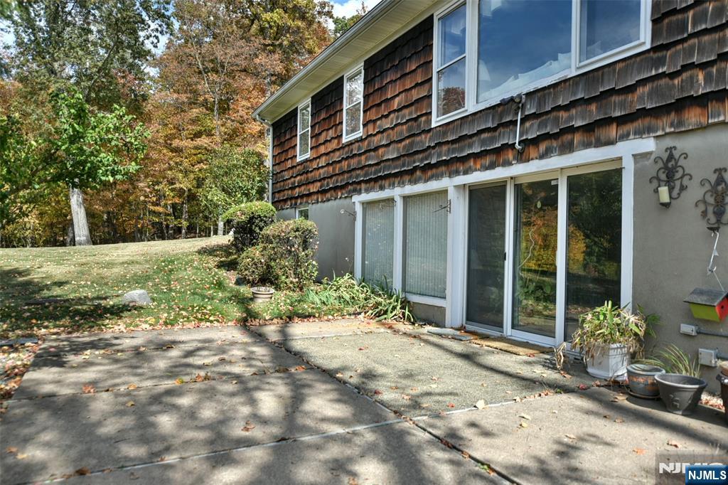 951 Berdan Avenue Wayne, NJ 07470 - Photo 35 of 39 a backyard of a house with large trees and plants