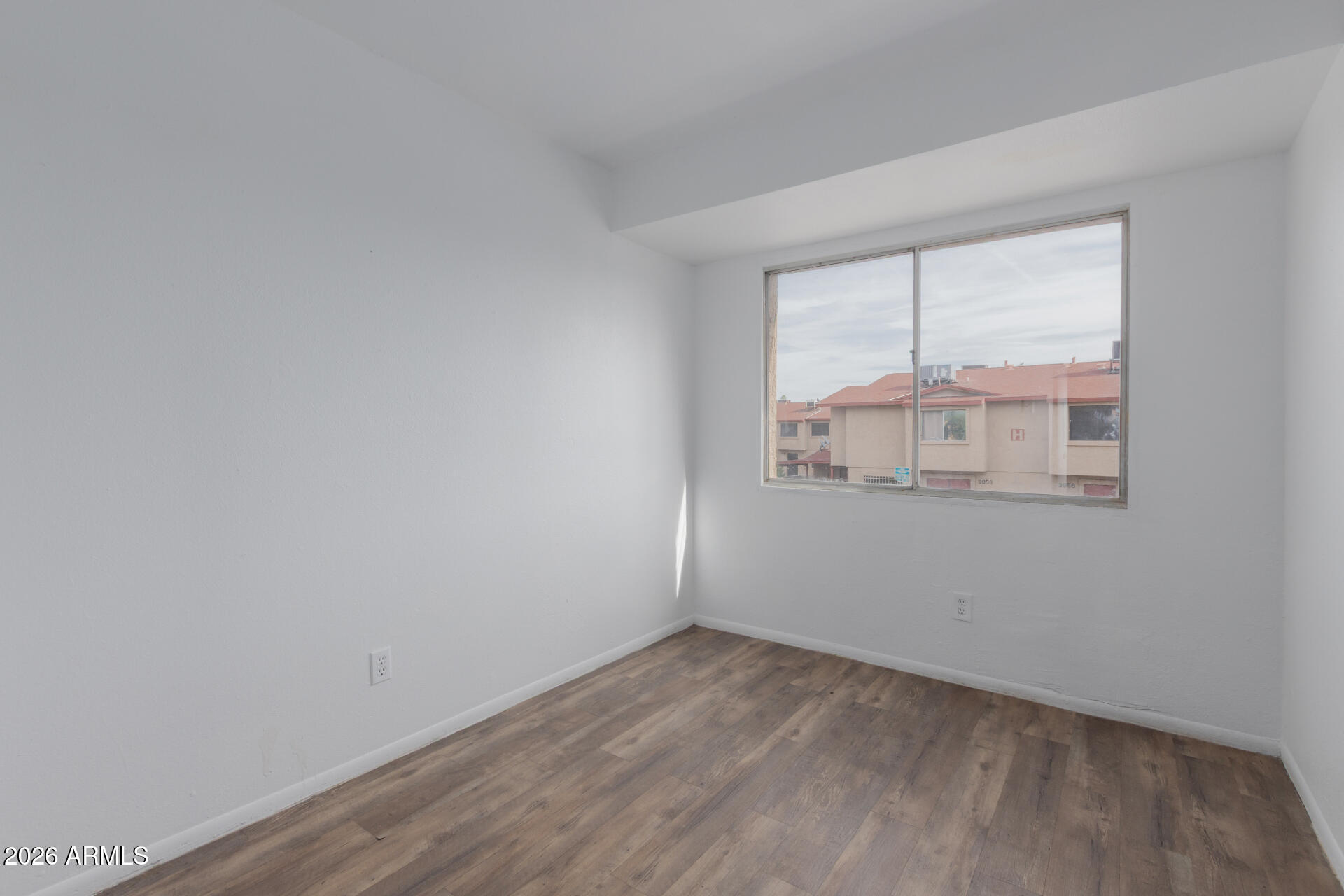 4002 West Palomino Road Phoenix, AZ 85019 - Photo 11 of 23 wooden floor in an empty room with a window