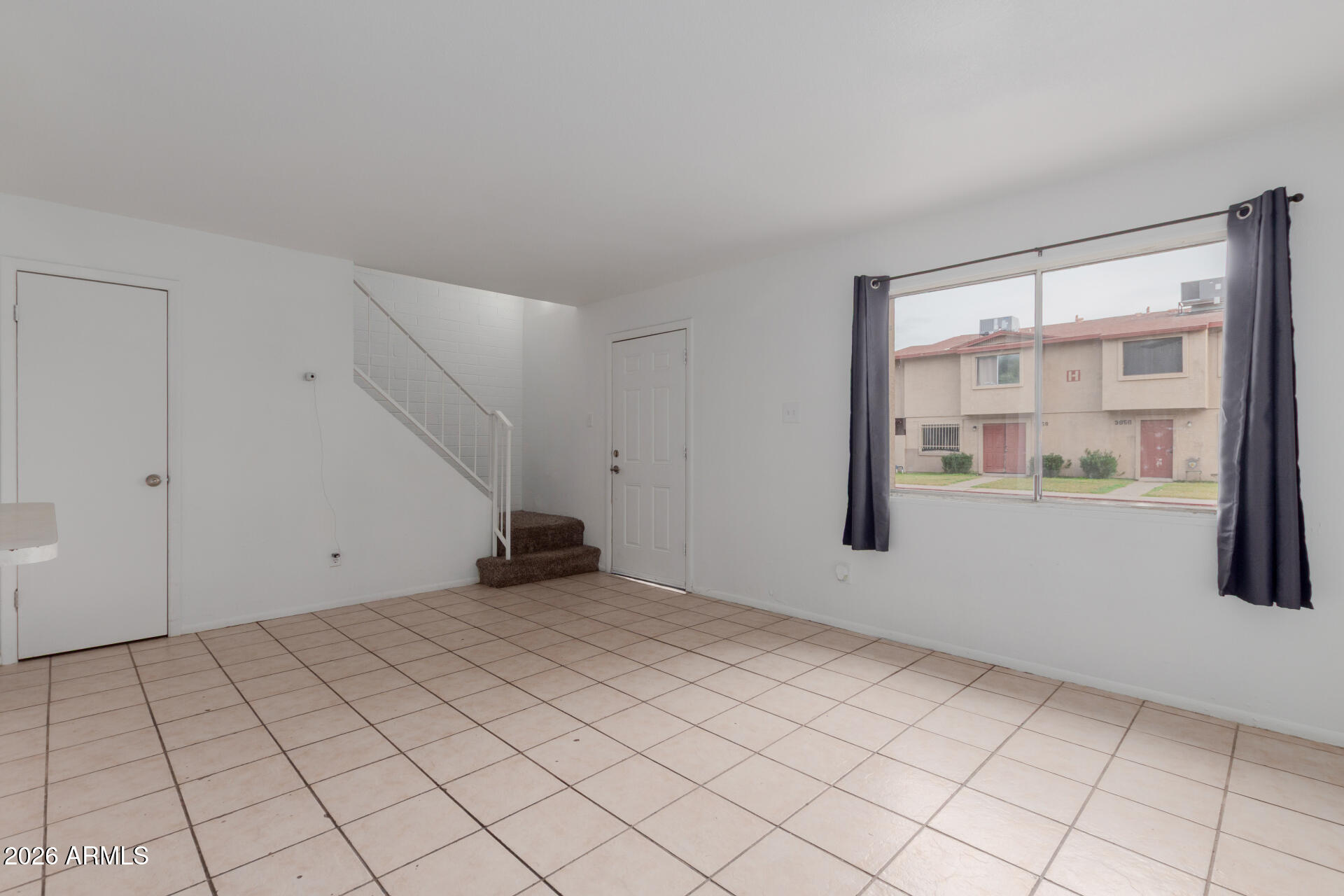 4002 West Palomino Road Phoenix, AZ 85019 - Photo 3 of 23 a view of an empty room with a window