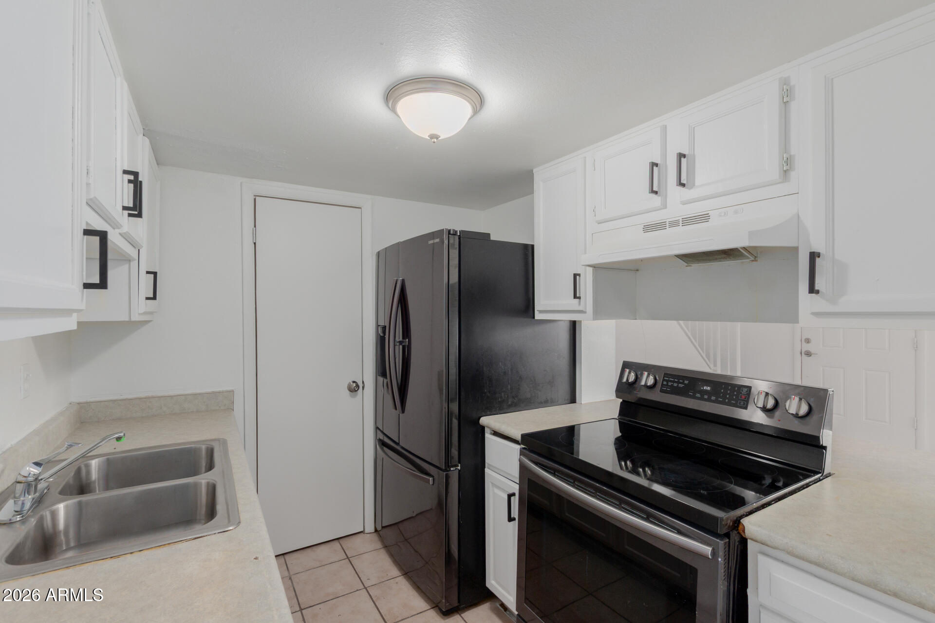 4002 West Palomino Road Phoenix, AZ 85019 - Photo 9 of 23 a kitchen with a refrigerator stove and sink