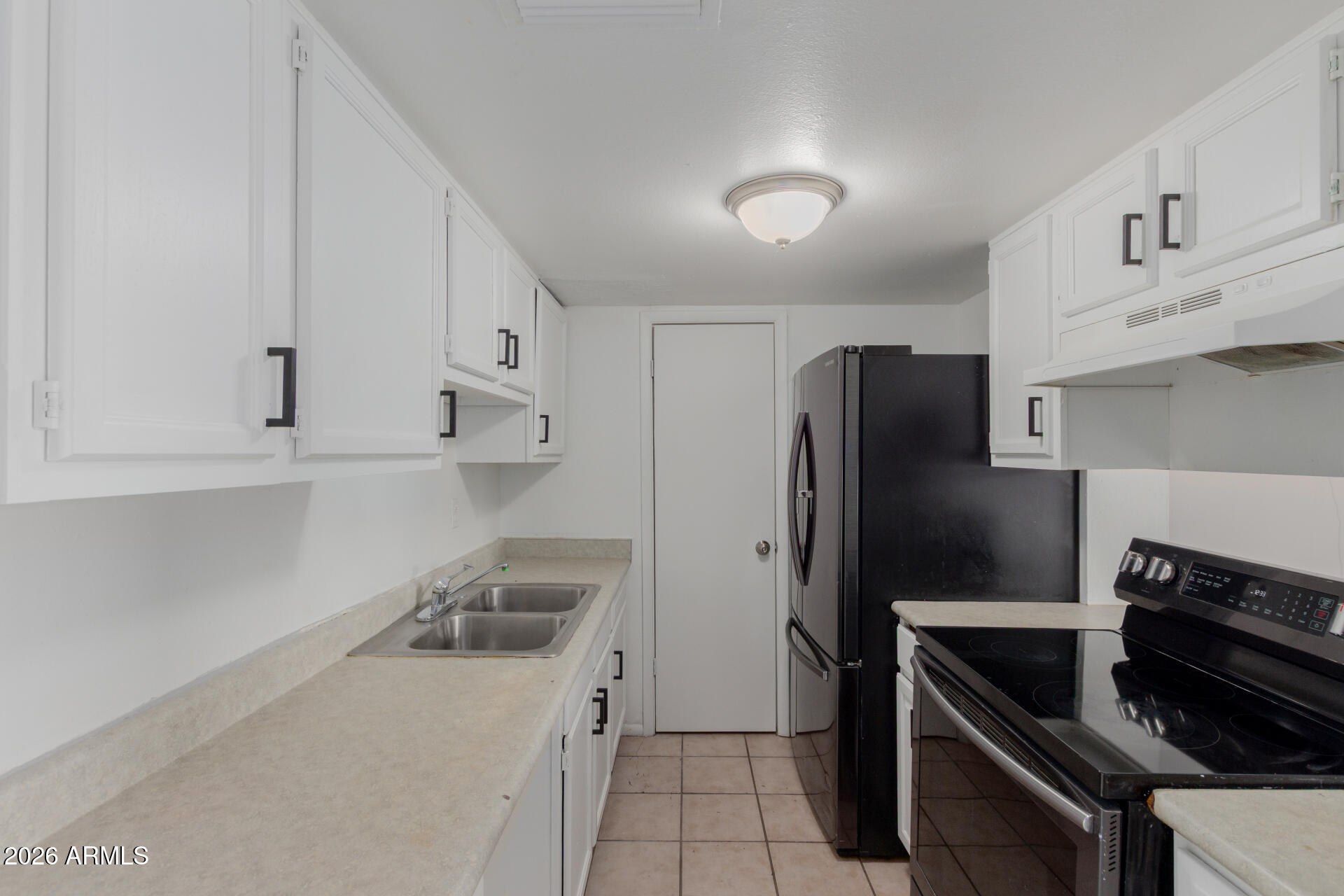 4002 West Palomino Road Phoenix, AZ 85019 - Photo 10 of 23 a kitchen with a refrigerator and a sink