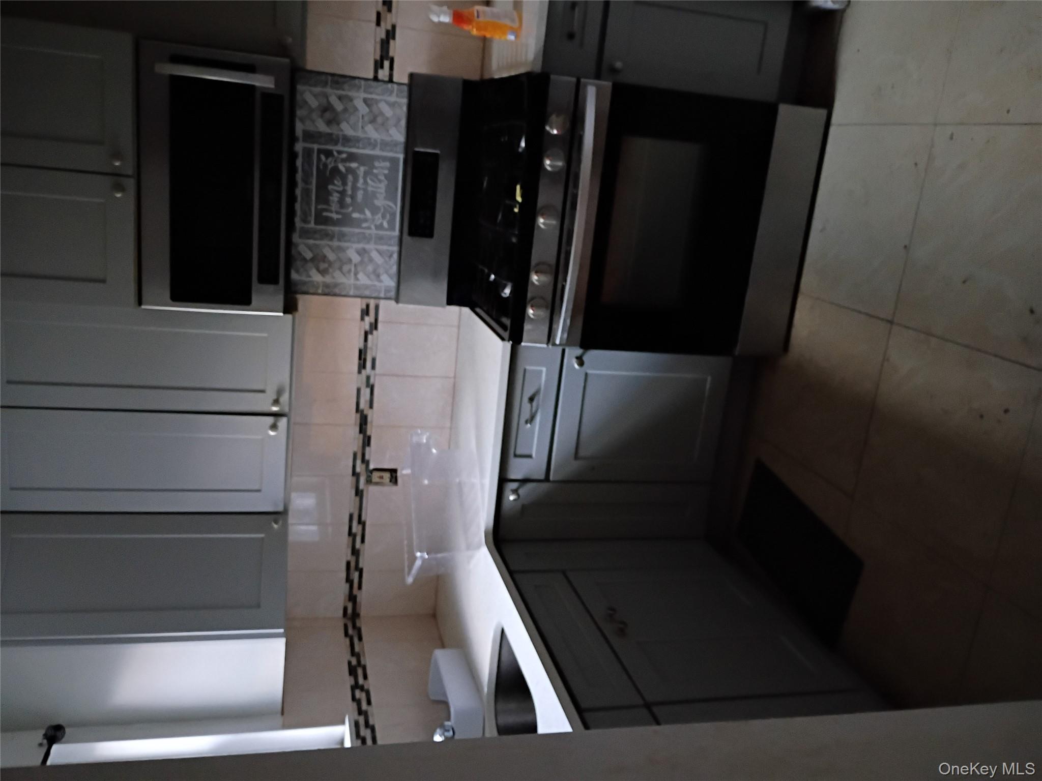 115-40 227th Street Queens, NY 11411 - Photo 6 of 9 a kitchen with a stove and a sink