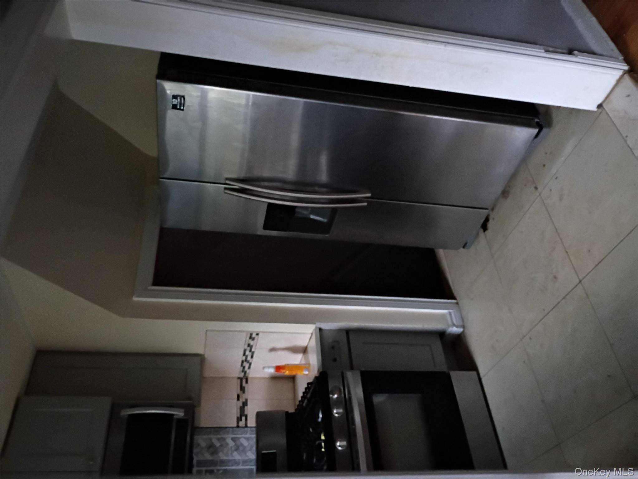 115-40 227th Street Queens, NY 11411 - Photo 7 of 9 a kitchen with stainless steel appliances granite countertop a refrigerator a stove and a sink