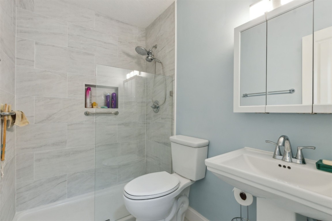 914 Jasmine Street Fernandina Beach, FL 32034 - Photo 13 of 19 a white toilet sitting next to a bathroom sink