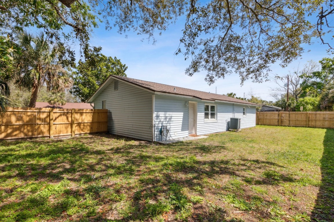 914 Jasmine Street Fernandina Beach, FL 32034 - Photo 16 of 19 a view of a house with a yard and garage