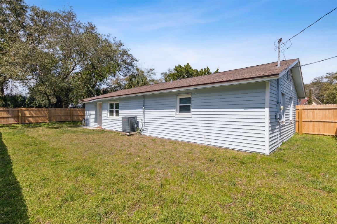 914 Jasmine Street Fernandina Beach, FL 32034 - Photo 17 of 19 a view of a house with a backyard and a tree