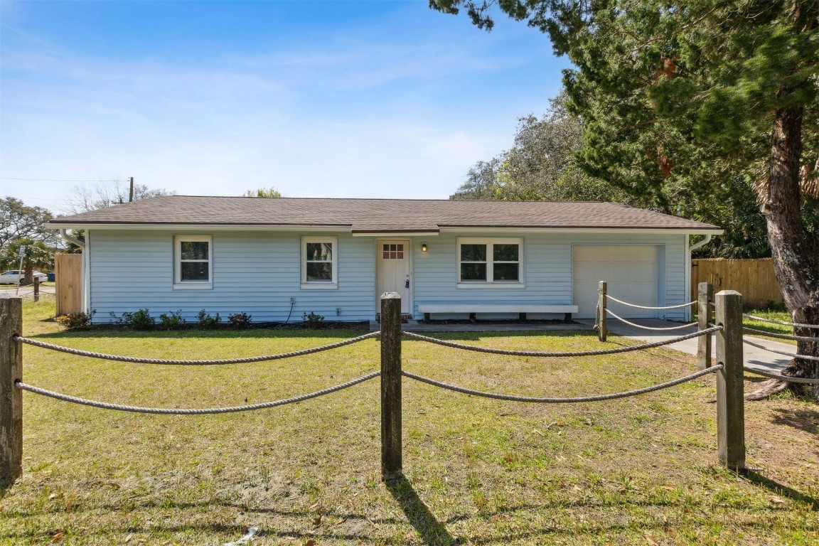 914 Jasmine Street Fernandina Beach, FL 32034 - Photo 2 of 19 a view of a house with swimming pool and a yard