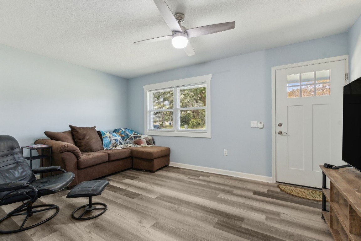 914 Jasmine Street Fernandina Beach, FL 32034 - Photo 4 of 19 a living room with furniture a window and a flat screen tv