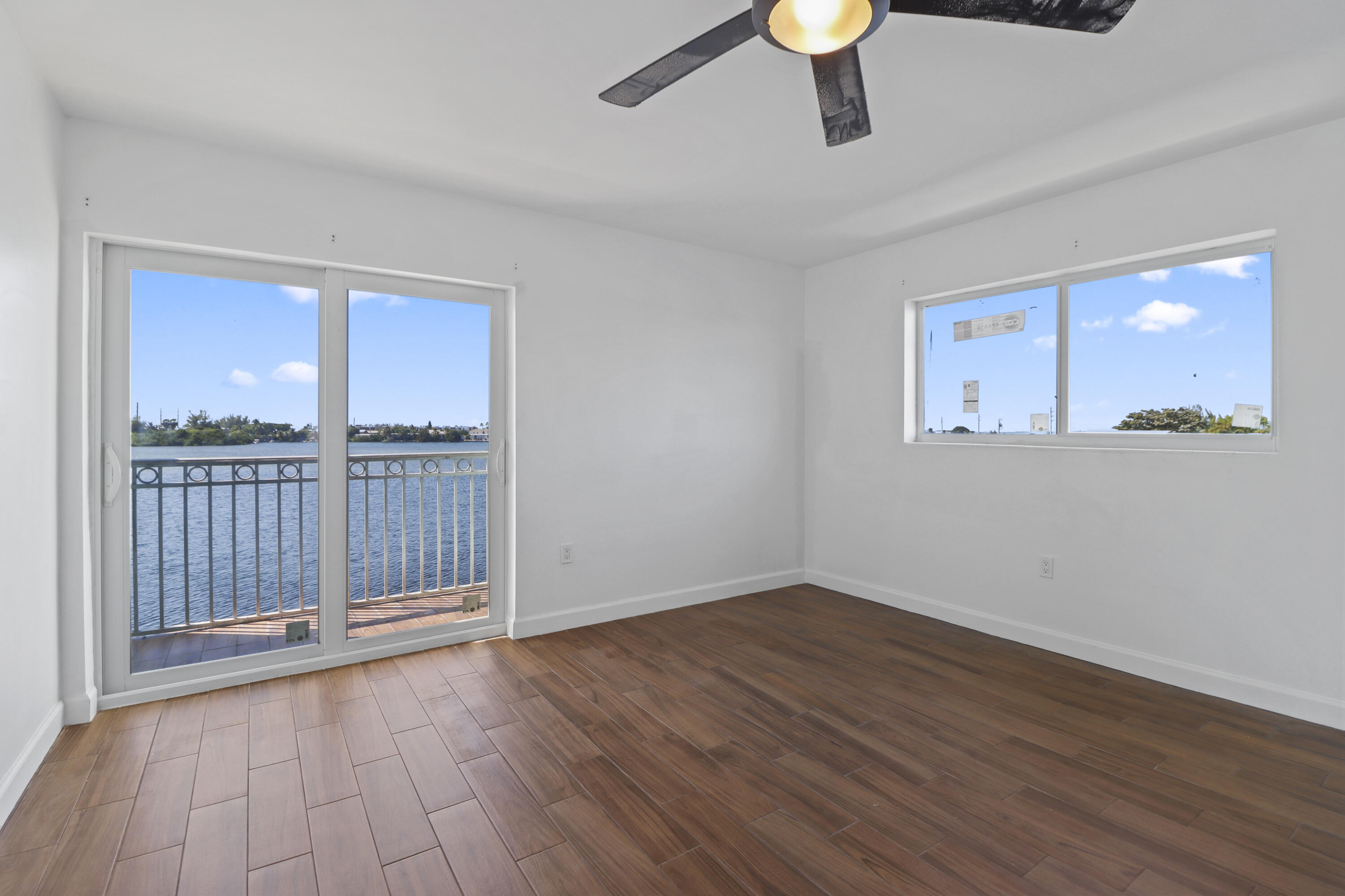 201 Coppitt Road, Unit 301A Key West, FL 33040 - Photo 13 of 25 a view of an empty room with wooden floor and a window