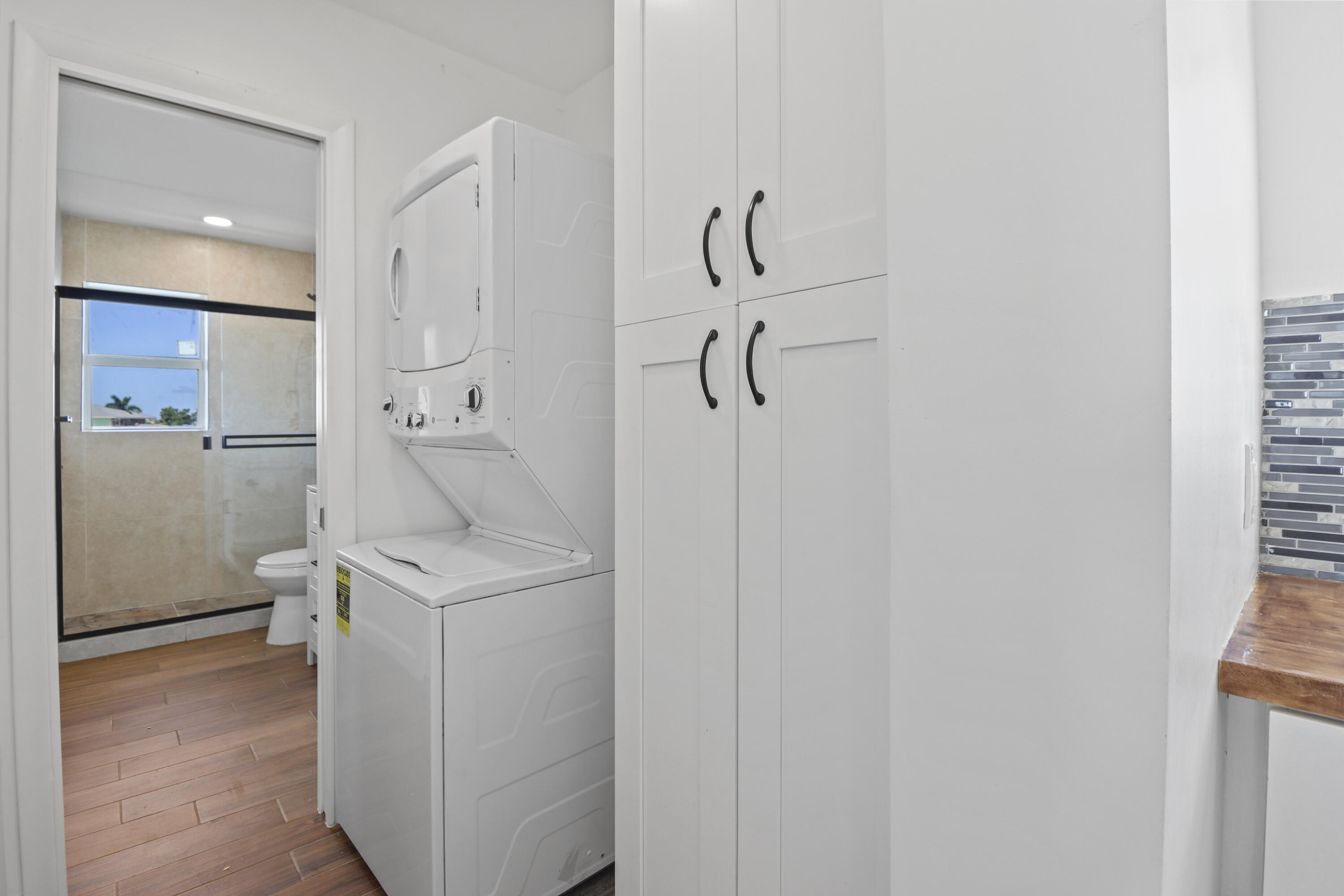 201 Coppitt Road, Unit 301A Key West, FL 33040 - Photo 18 of 25 a utility room with cabinets washer and dryer