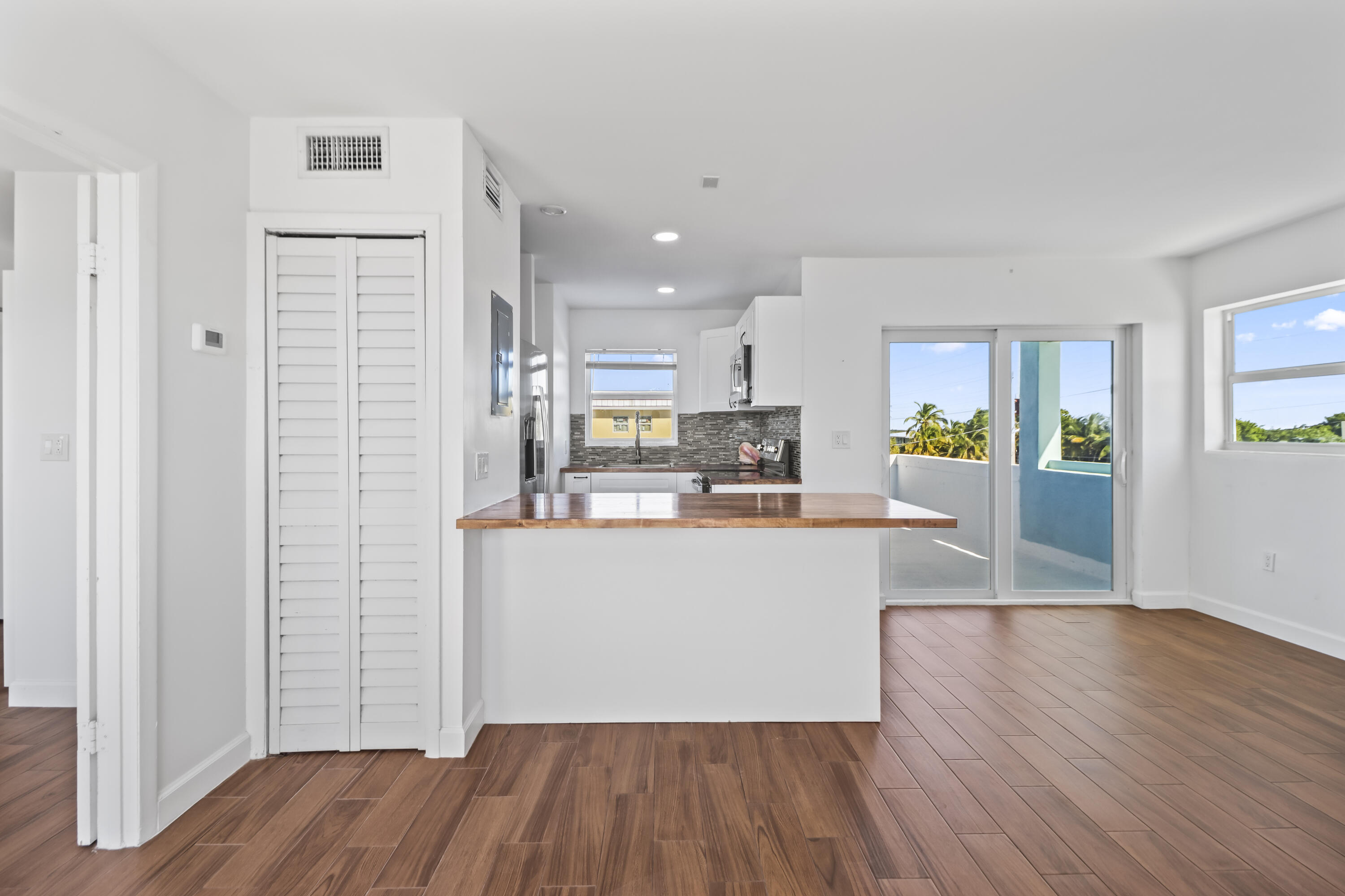 201 Coppitt Road, Unit 301A Key West, FL 33040 - Photo 20 of 25 a living room with stainless steel appliances wooden floors and kitchen view