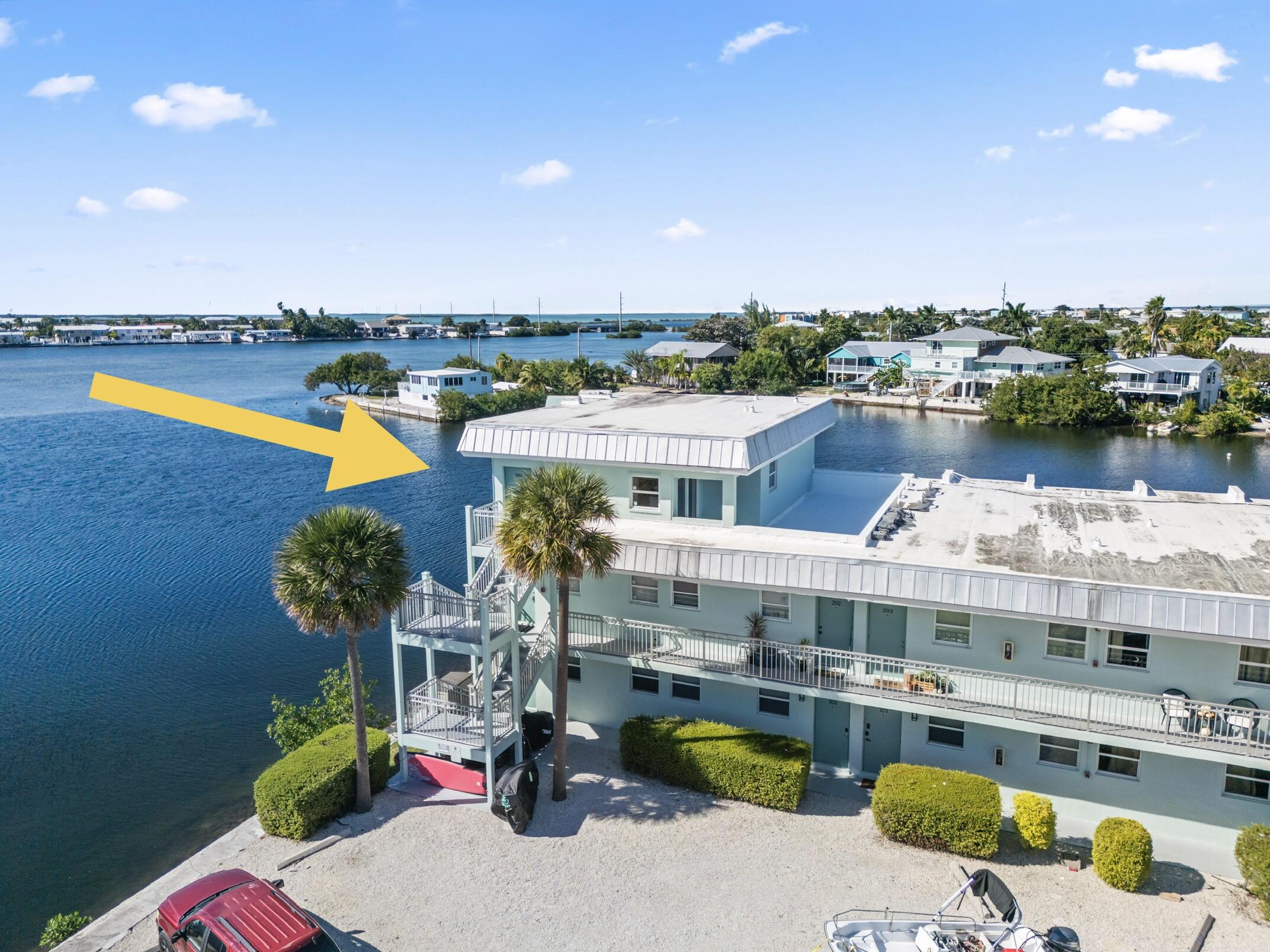 201 Coppitt Road, Unit 301A Key West, FL 33040 - Photo 2 of 25 a swimming pool with outdoor seating and yard