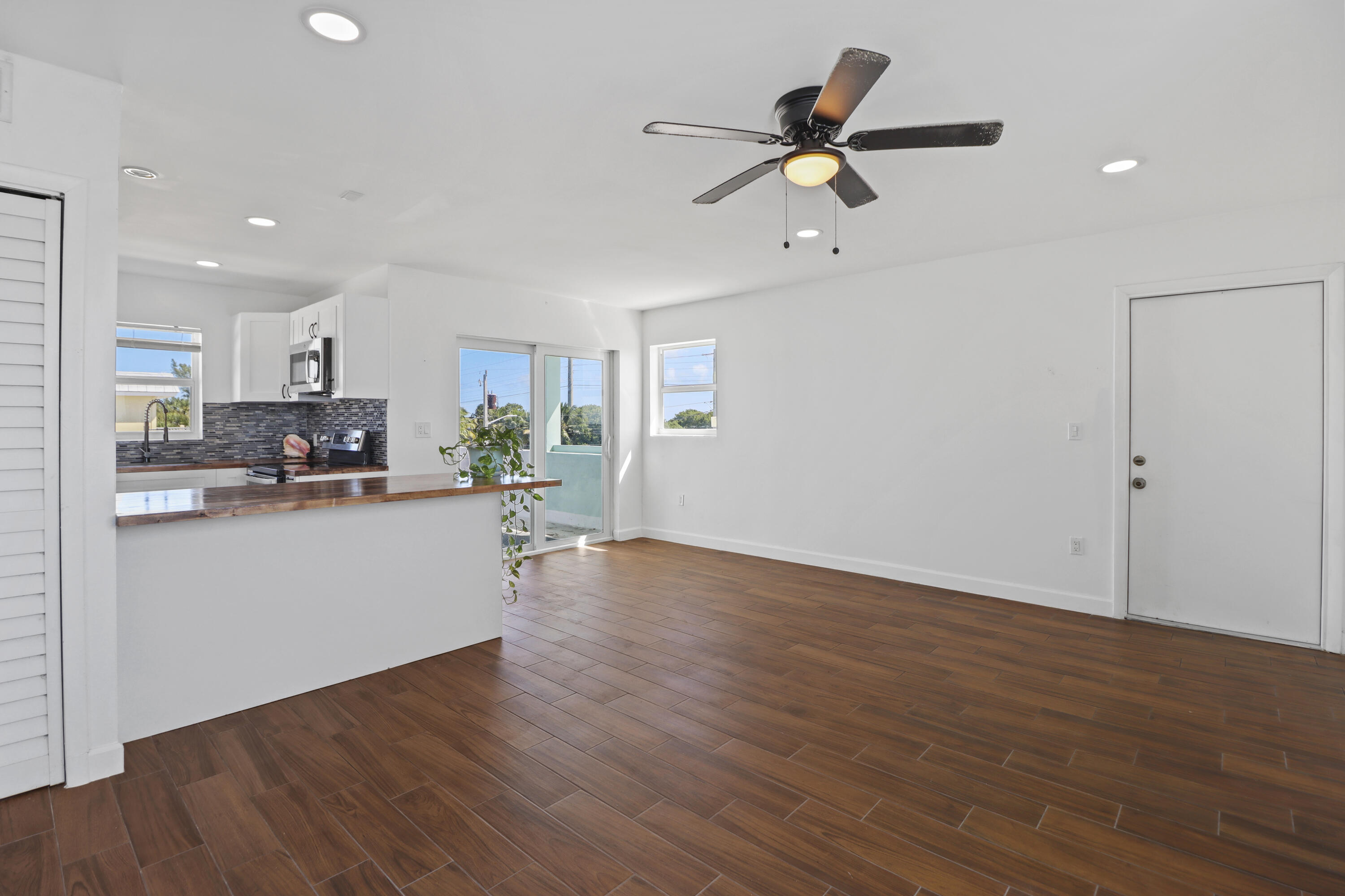 201 Coppitt Road, Unit 301A Key West, FL 33040 - Photo 5 of 25 a view of a kitchen with furniture a ceiling fan and wooden floor