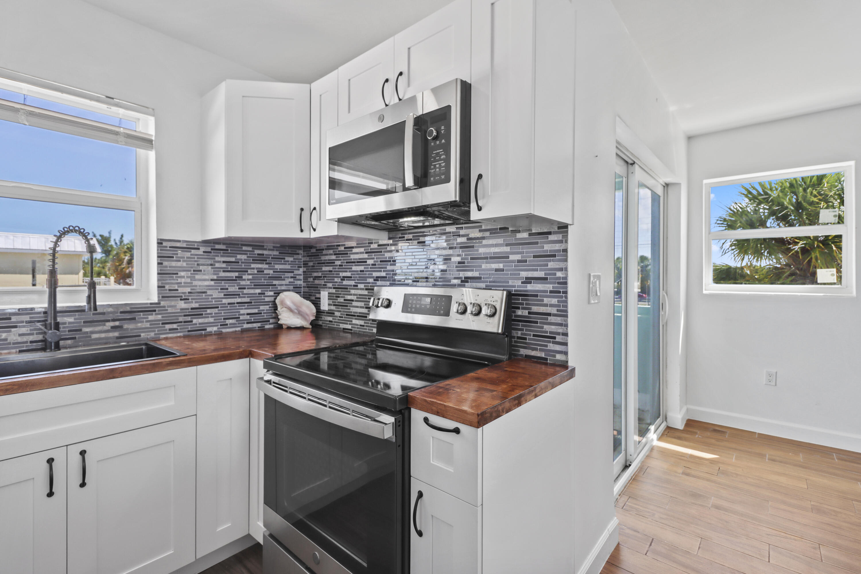 201 Coppitt Road, Unit 301A Key West, FL 33040 - Photo 7 of 25 a kitchen with a stove and a microwave