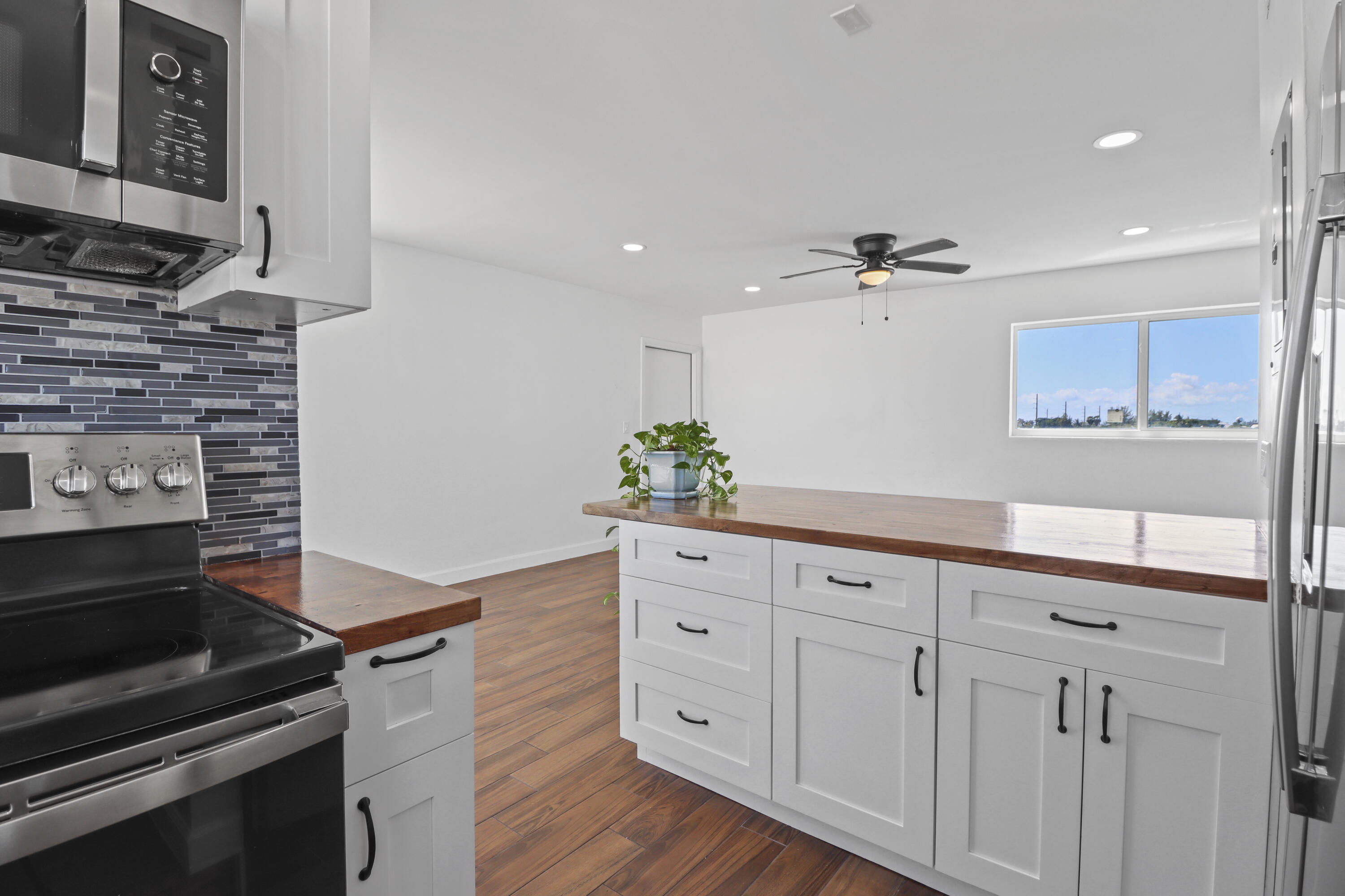 201 Coppitt Road, Unit 301A Key West, FL 33040 - Photo 9 of 25 a kitchen with white cabinets and appliances