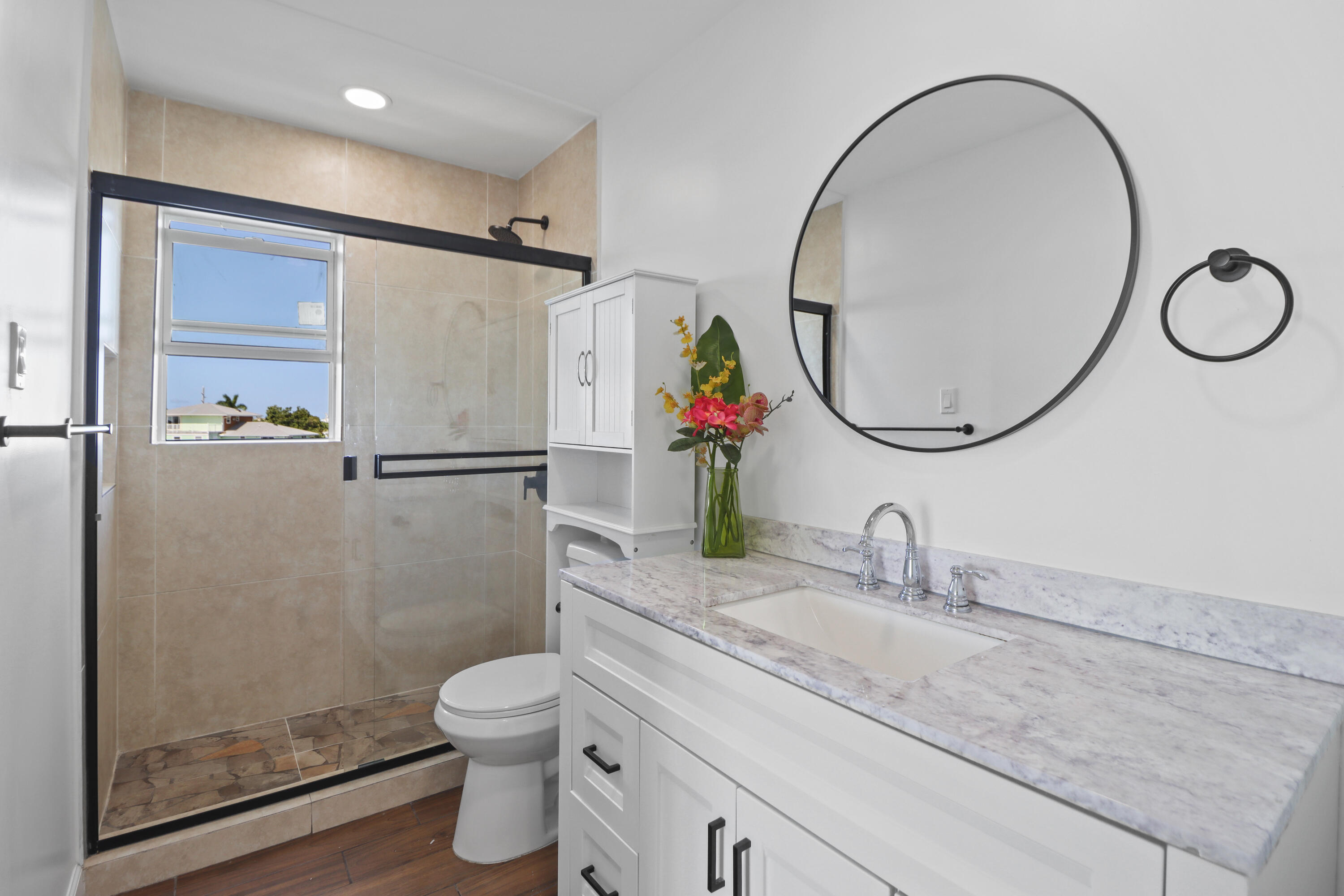 201 Coppitt Road, Unit 301A Key West, FL 33040 - Photo 10 of 25 a bathroom with a granite countertop toilet sink and mirror