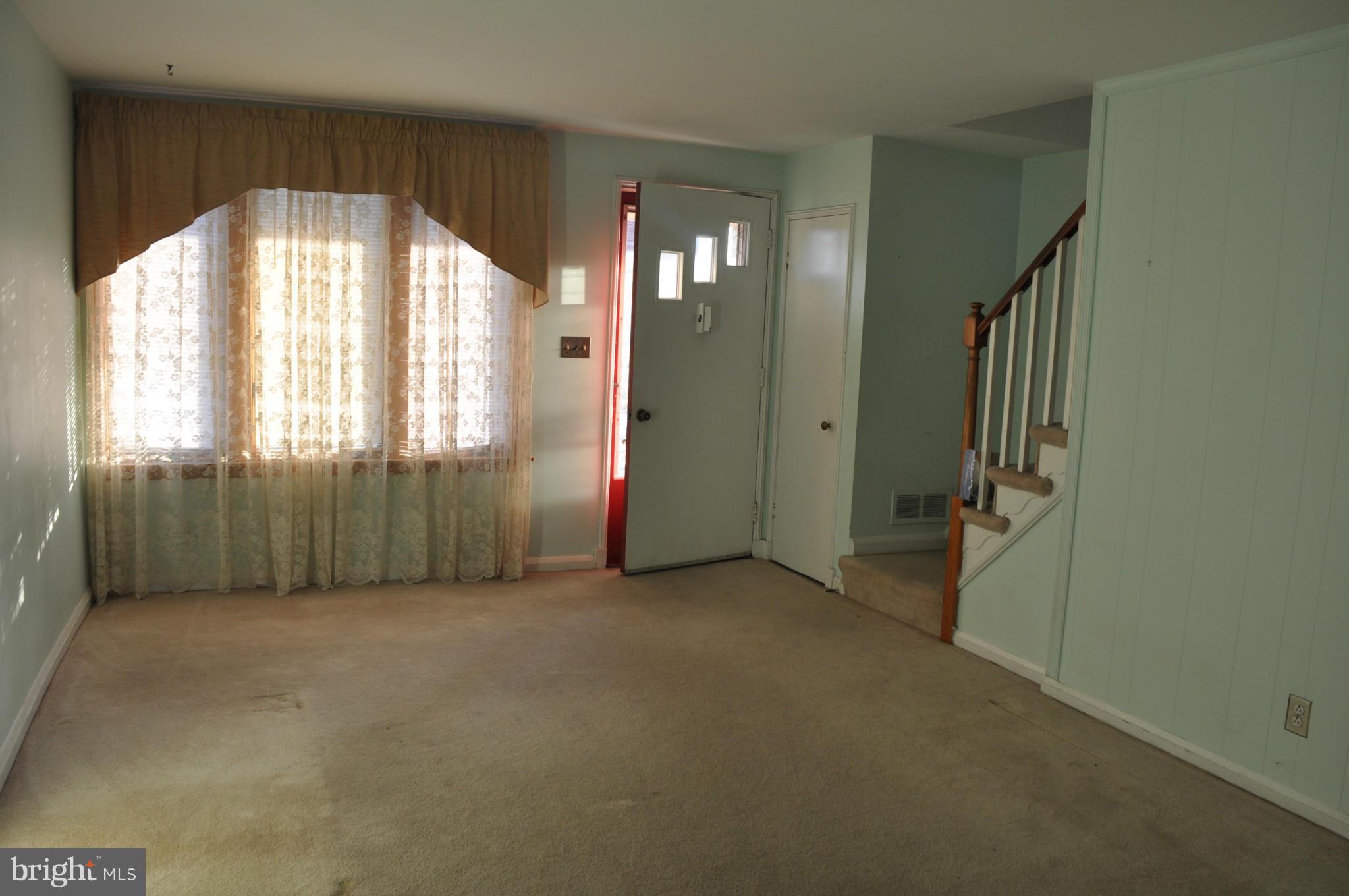 7438 Edsworth Road Baltimore, MD 21222 - Photo 4 of 12 an empty room with windows and closet