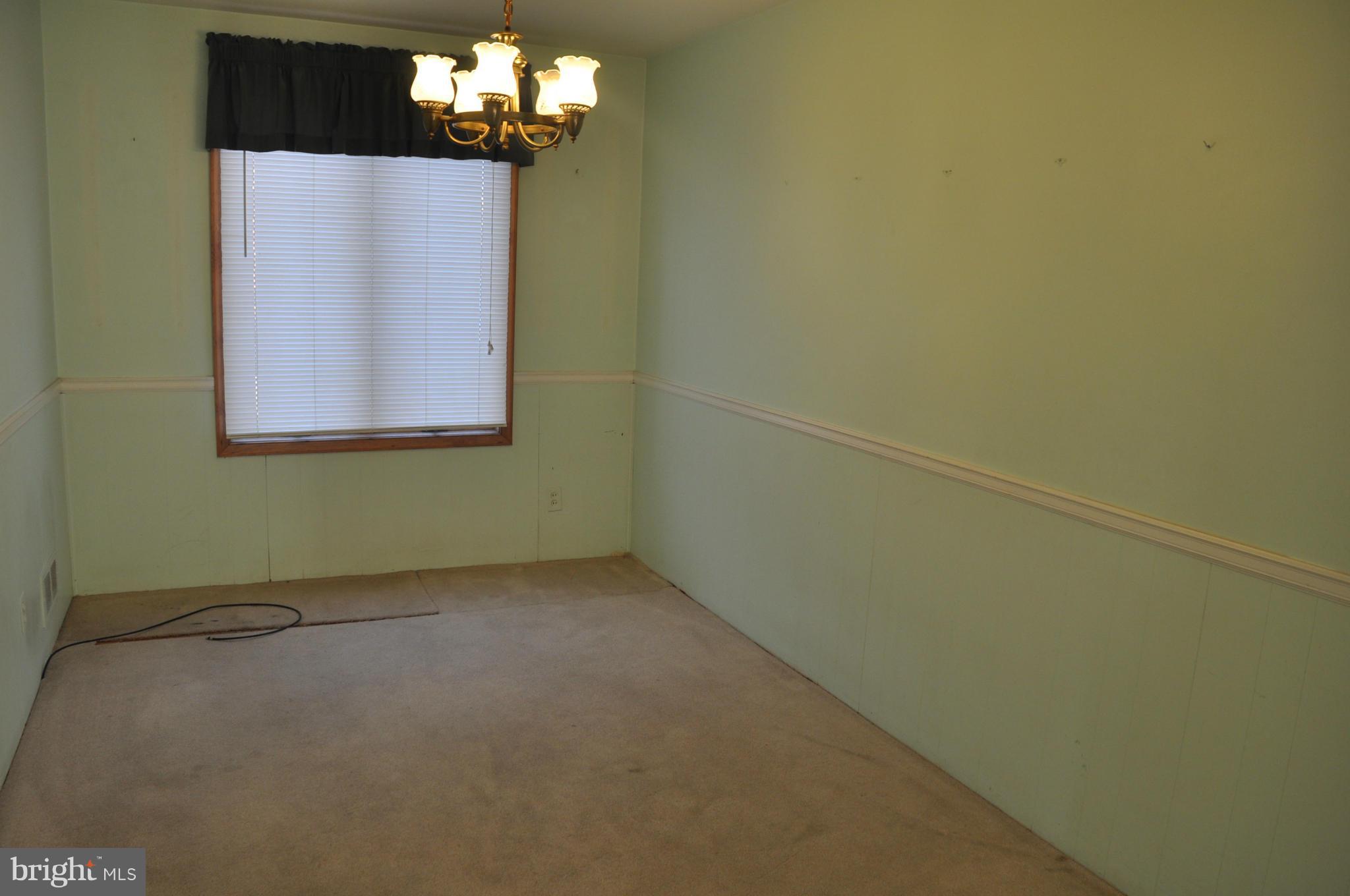 7438 Edsworth Road Baltimore, MD 21222 - Photo 5 of 12 a view of a chandelier in a room