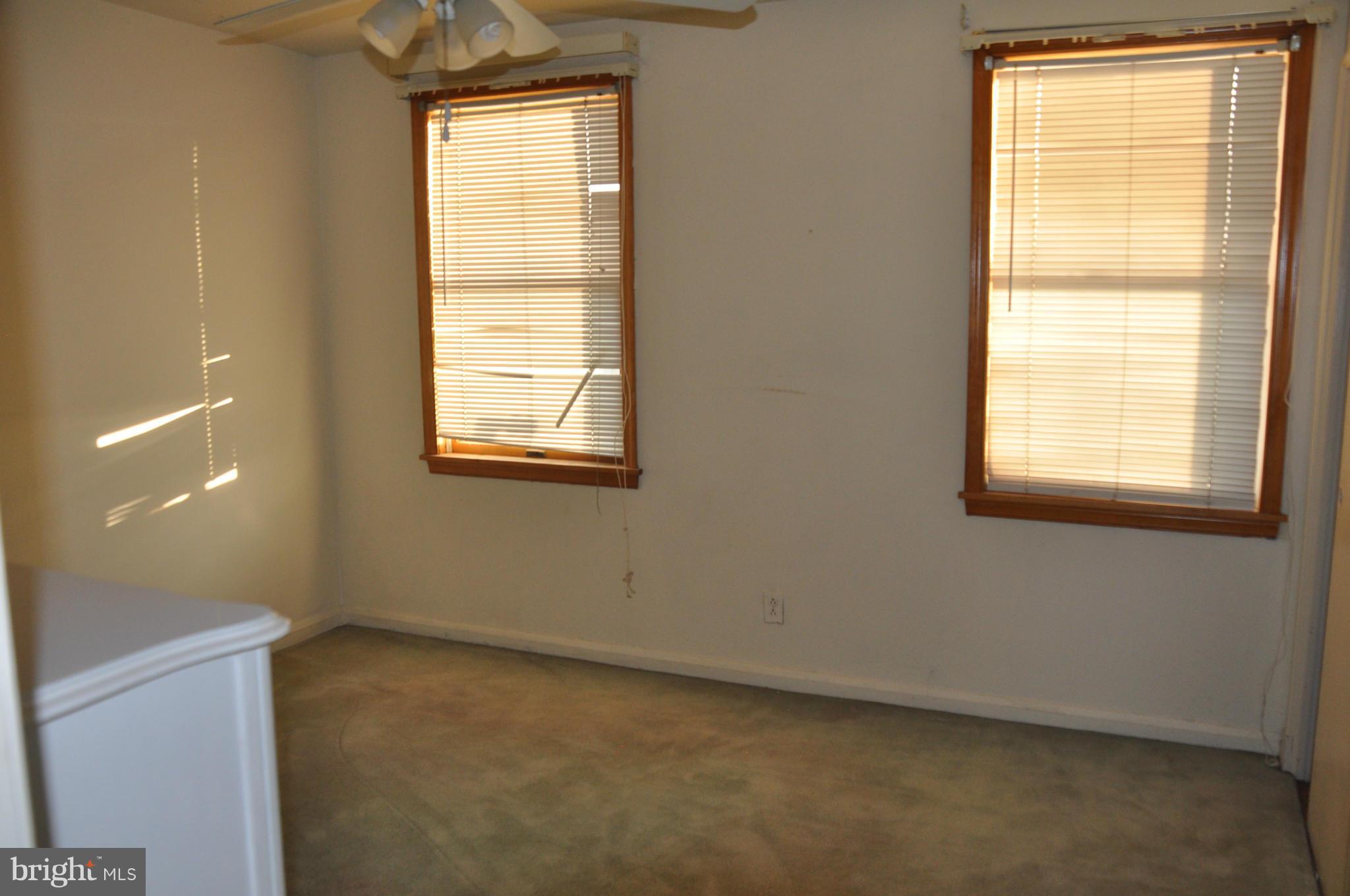 7438 Edsworth Road Baltimore, MD 21222 - Photo 7 of 12 an empty room with a window