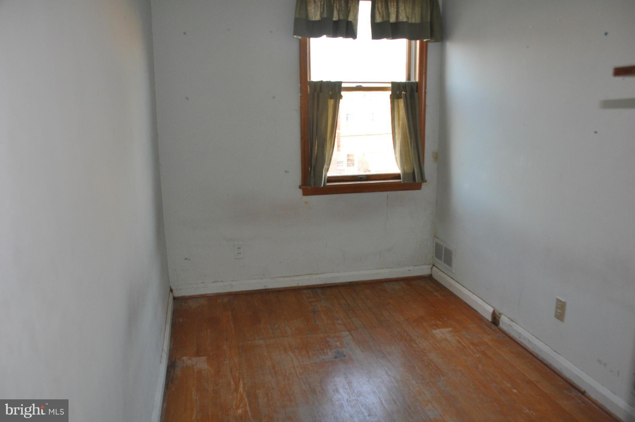 7438 Edsworth Road Baltimore, MD 21222 - Photo 8 of 12 an empty room with a window
