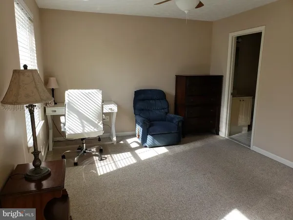 a living room with furniture and a lamp