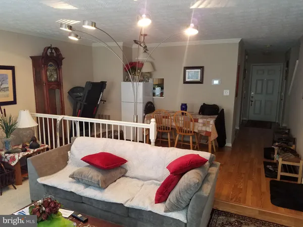 a living room with furniture and a lamp