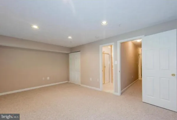an empty room with windows and closet