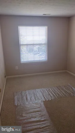 a bedroom with a bed and dresser