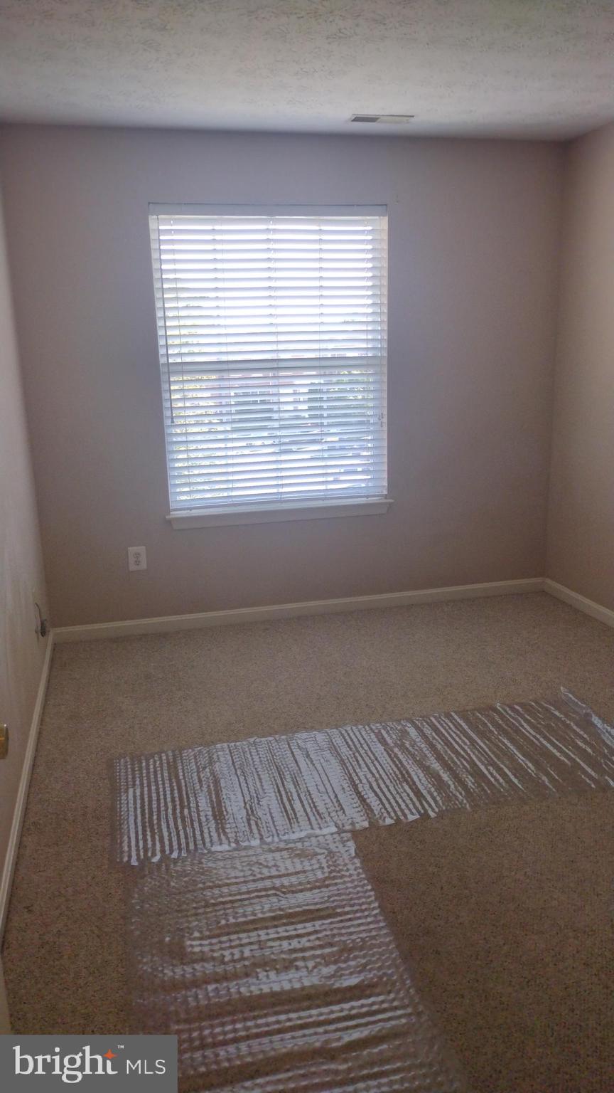 7151 Natures Road Columbia, MD 21046 - Photo 23 of 33 an empty room with wooden floor and windows
