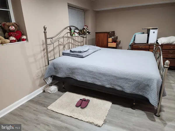 a bedroom with a bed and a painting on the wall