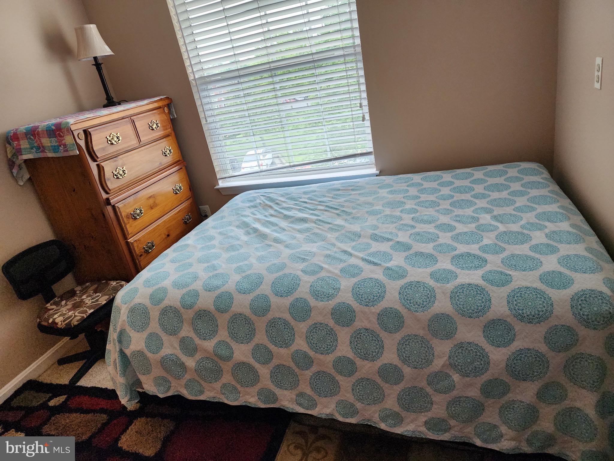 7151 Natures Road Columbia, MD 21046 - Photo 26 of 33 a bedroom with a bed and a painting on the wall